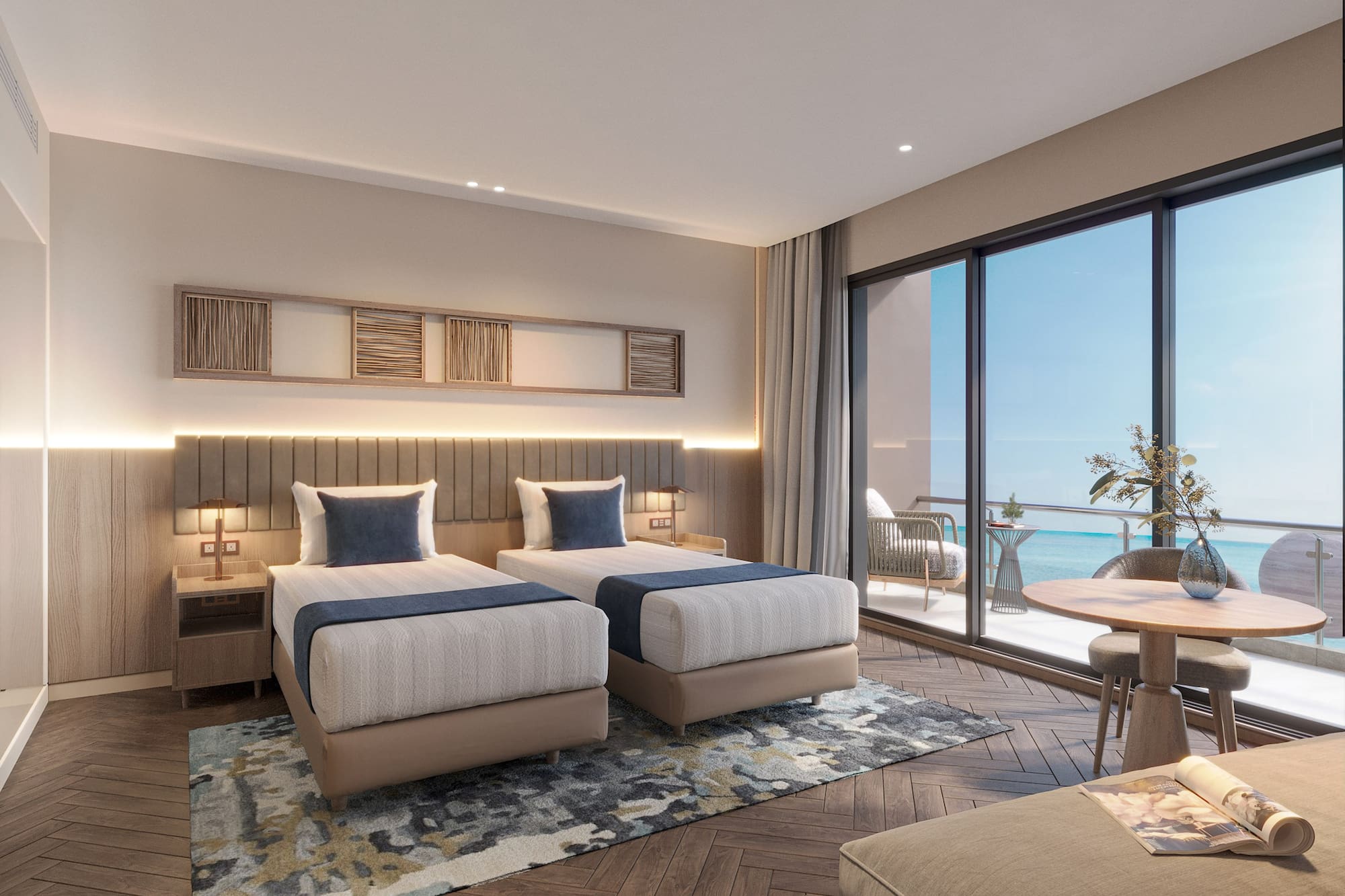 a room with two beds and a table and chairs