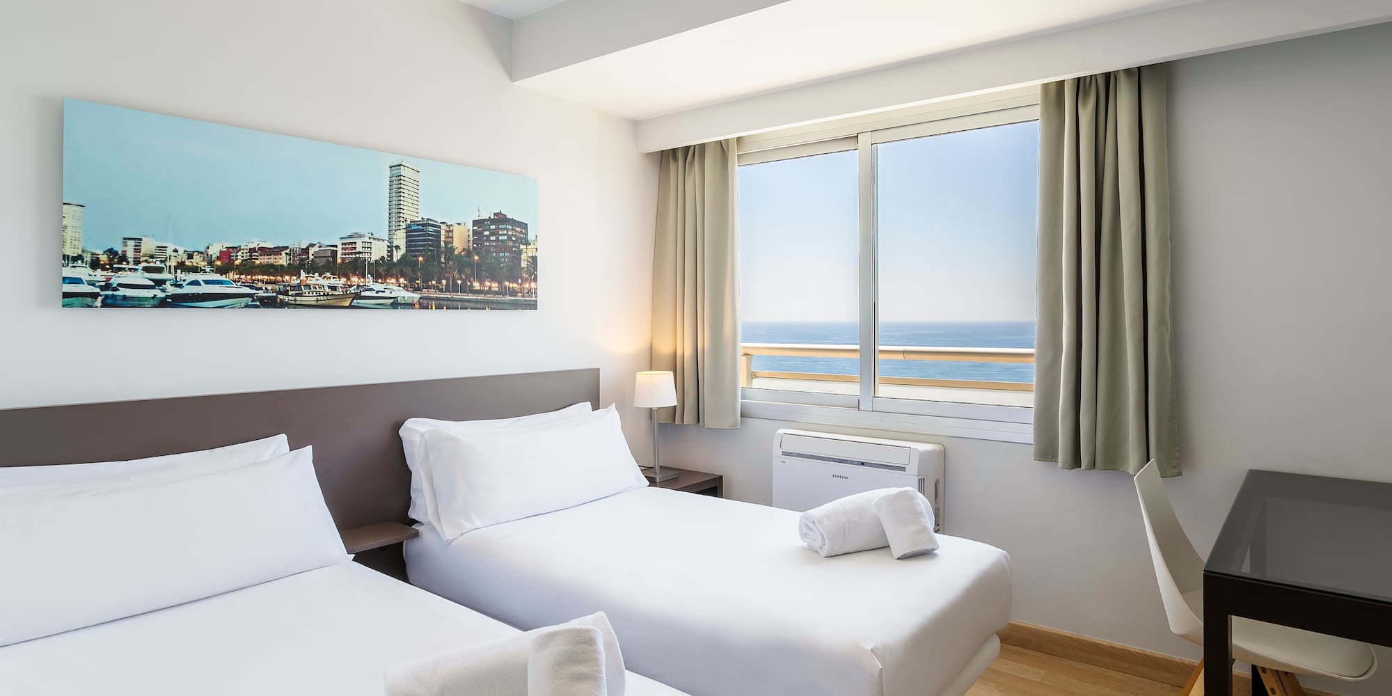 a room with two beds and a window