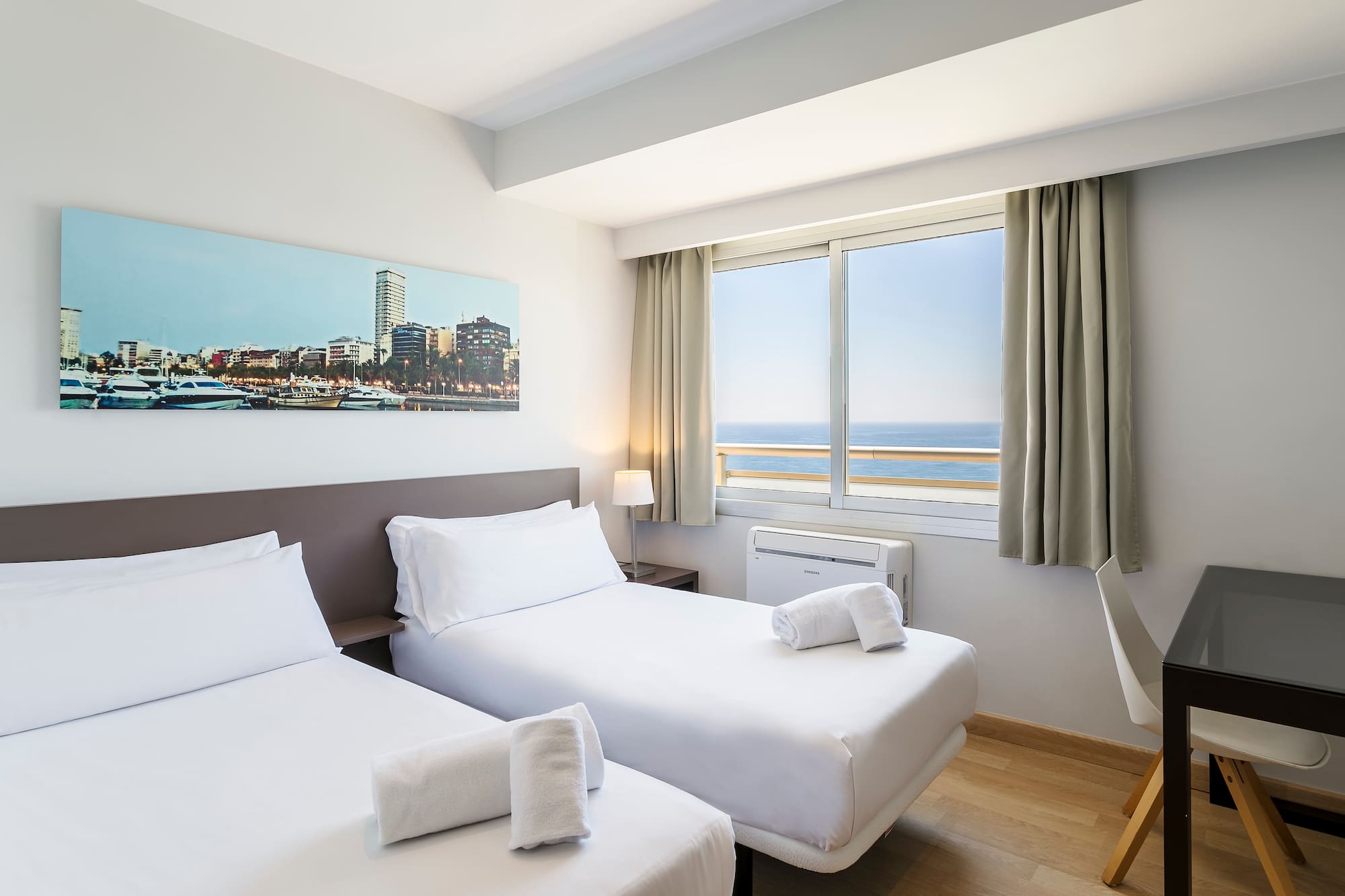 a room with two beds and a window