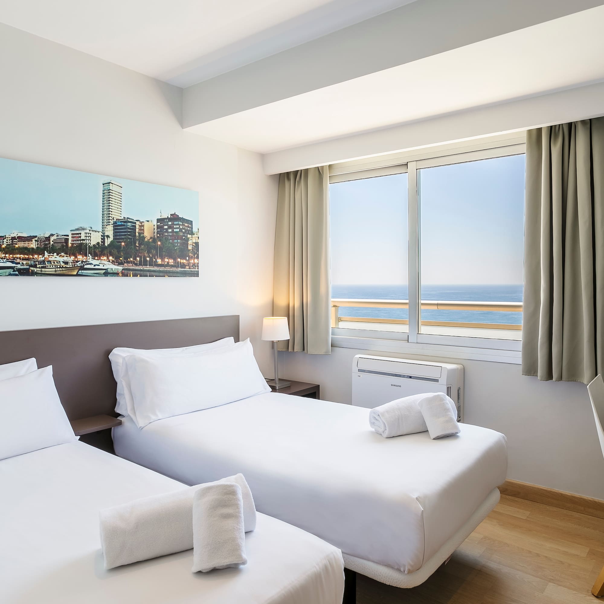 a room with two beds and a window