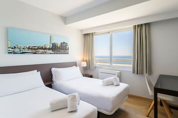a room with two beds and a window