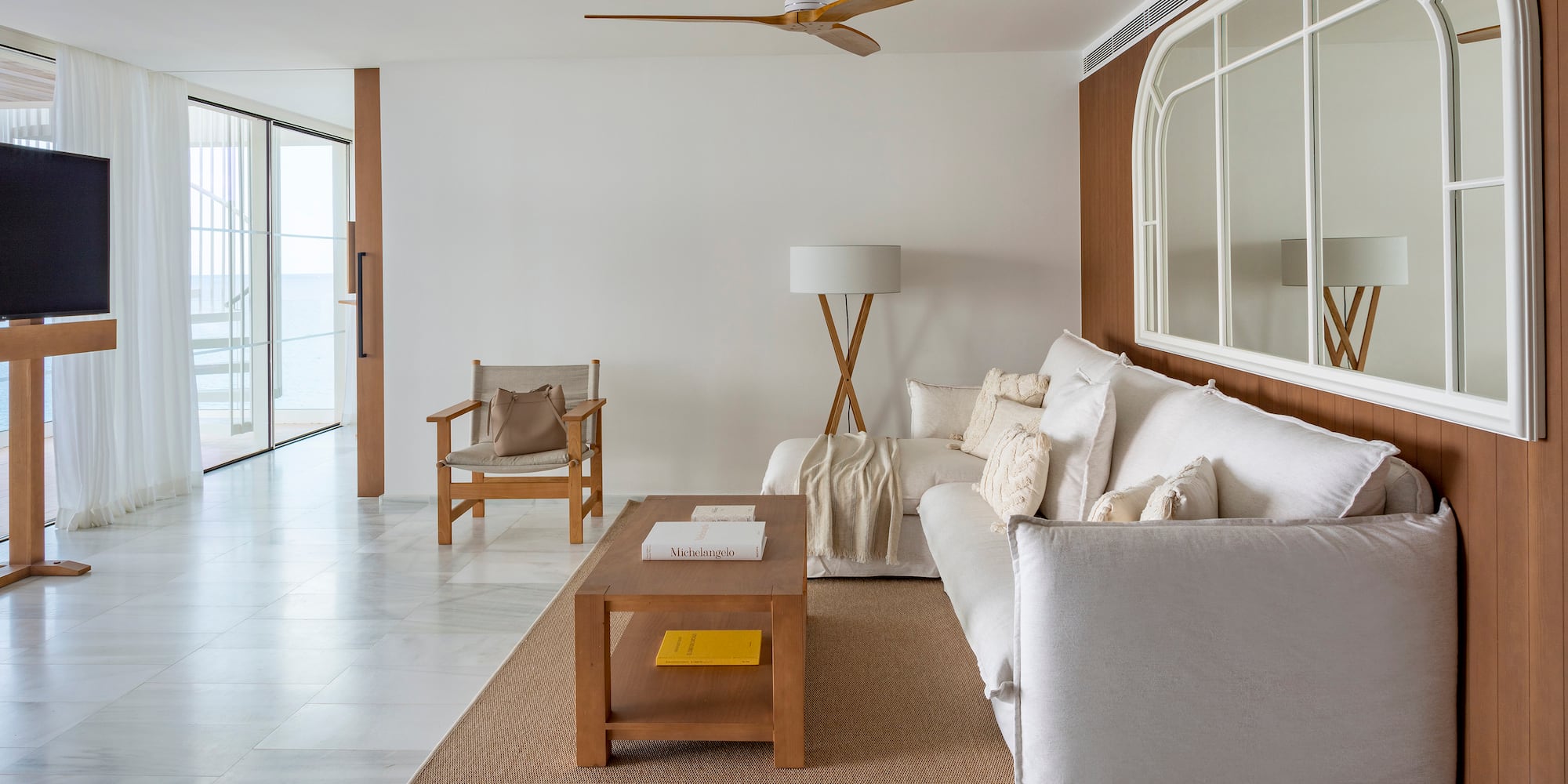 a living room with a white couch and a table