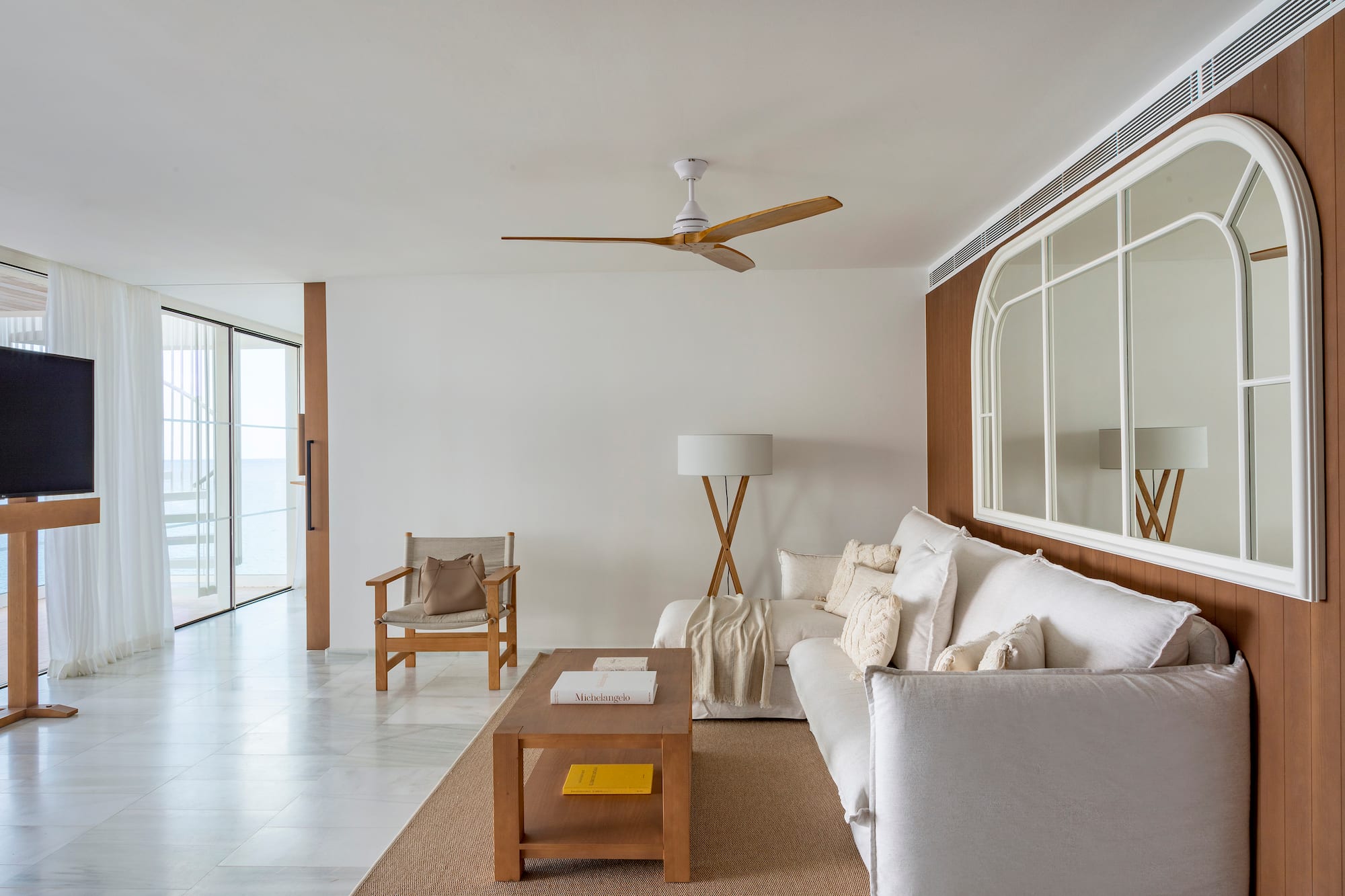 a living room with a white couch and a table