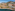 Benalmádena Holiday World resort: hotels, pools, rocky beach, mountains.
