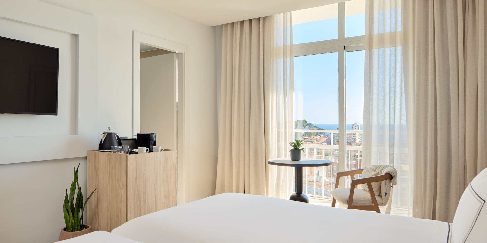 a room with a balcony and a table and chairs