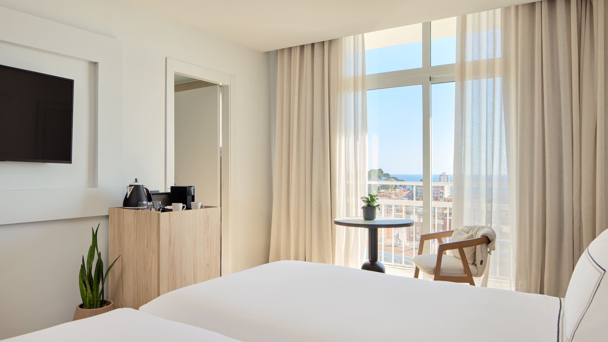 a room with a balcony and a table and chairs