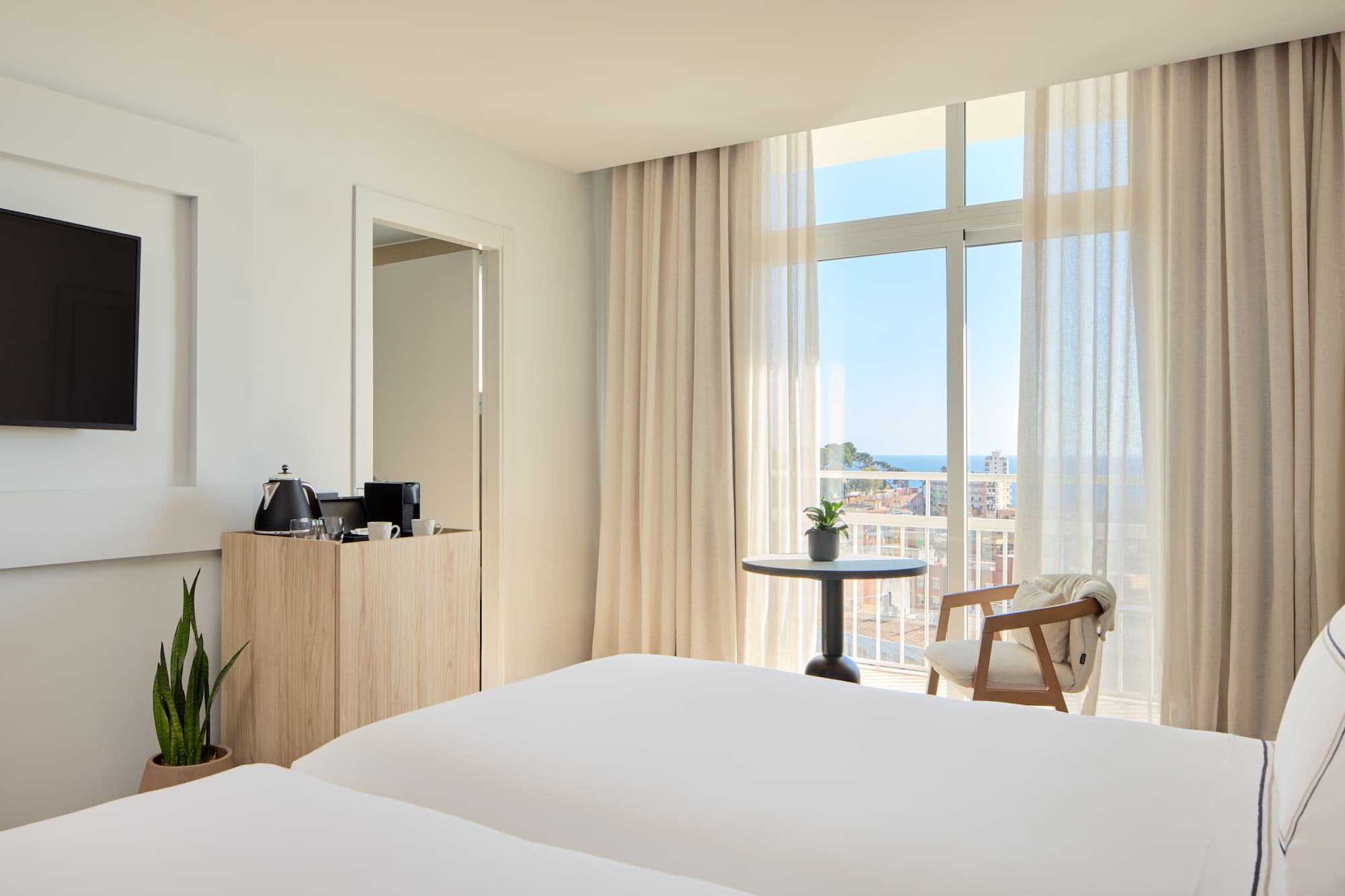 a room with a balcony and a table and chairs