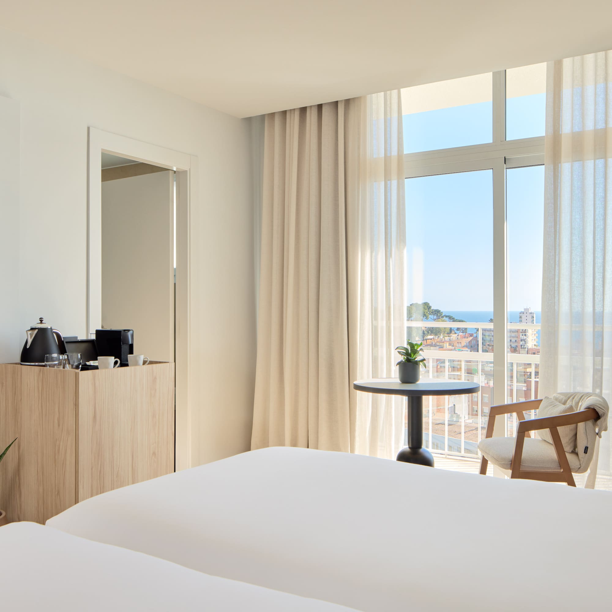 a room with a balcony and a table and chairs