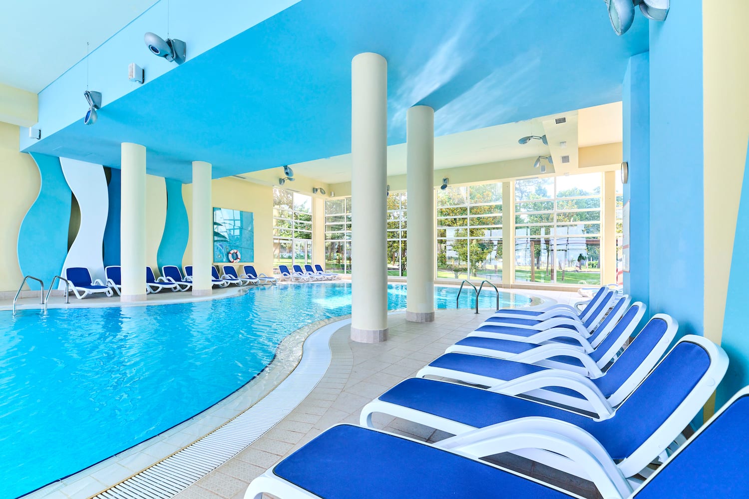 a pool with chairs and a large pool