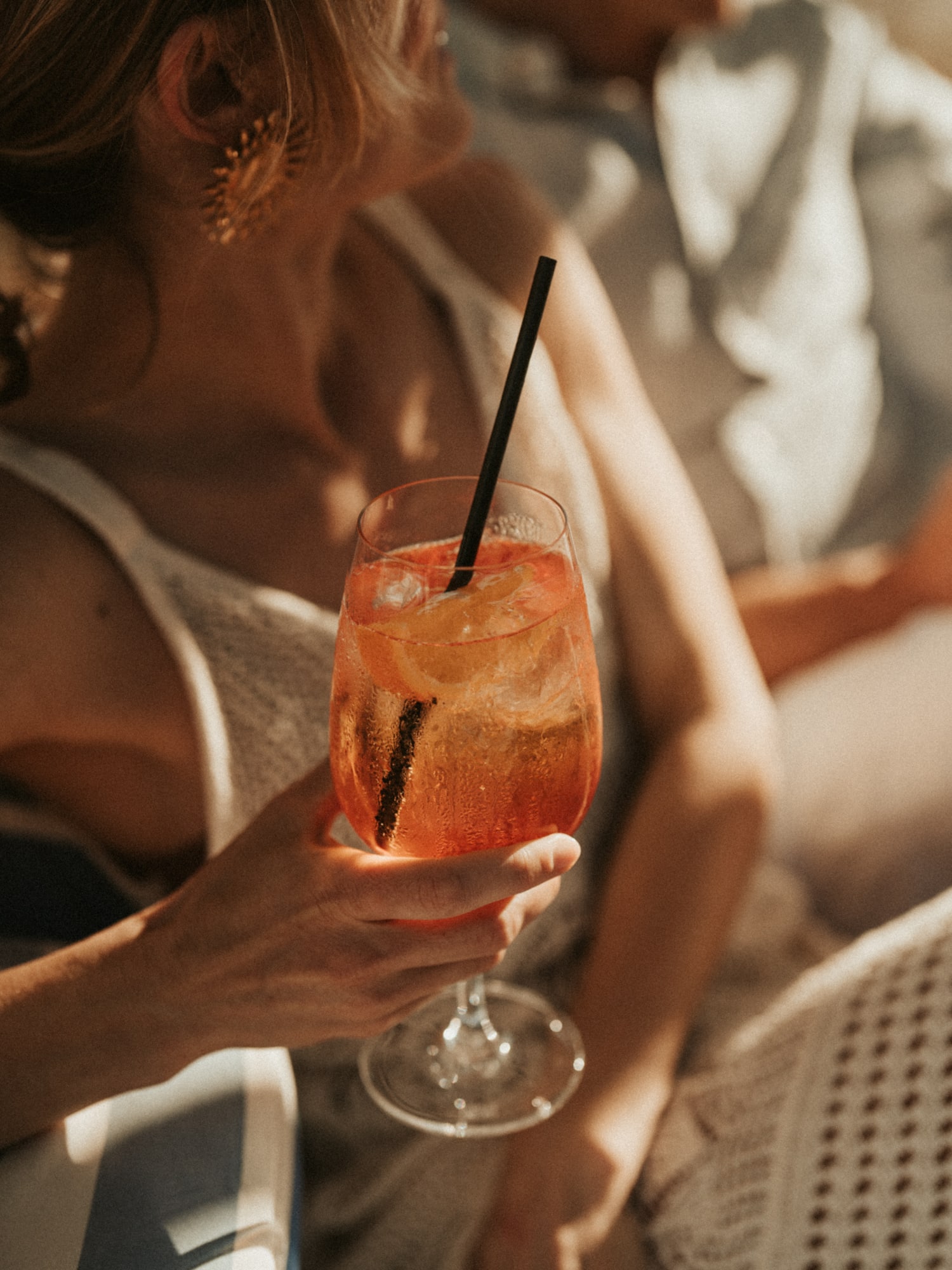a woman holding a drink