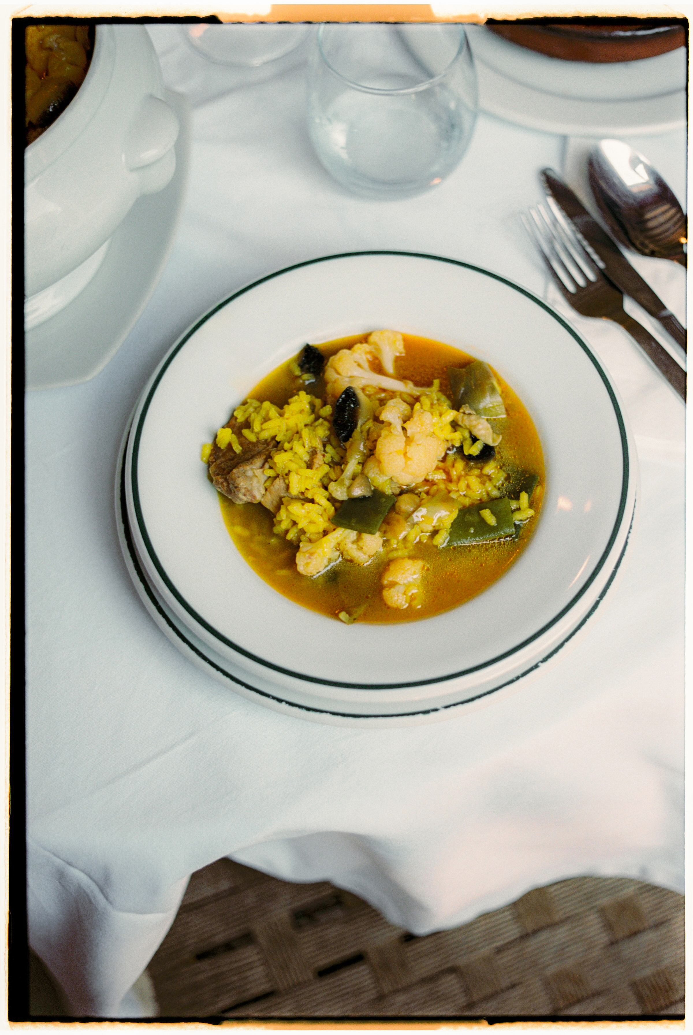 a bowl of soup with rice and vegetables