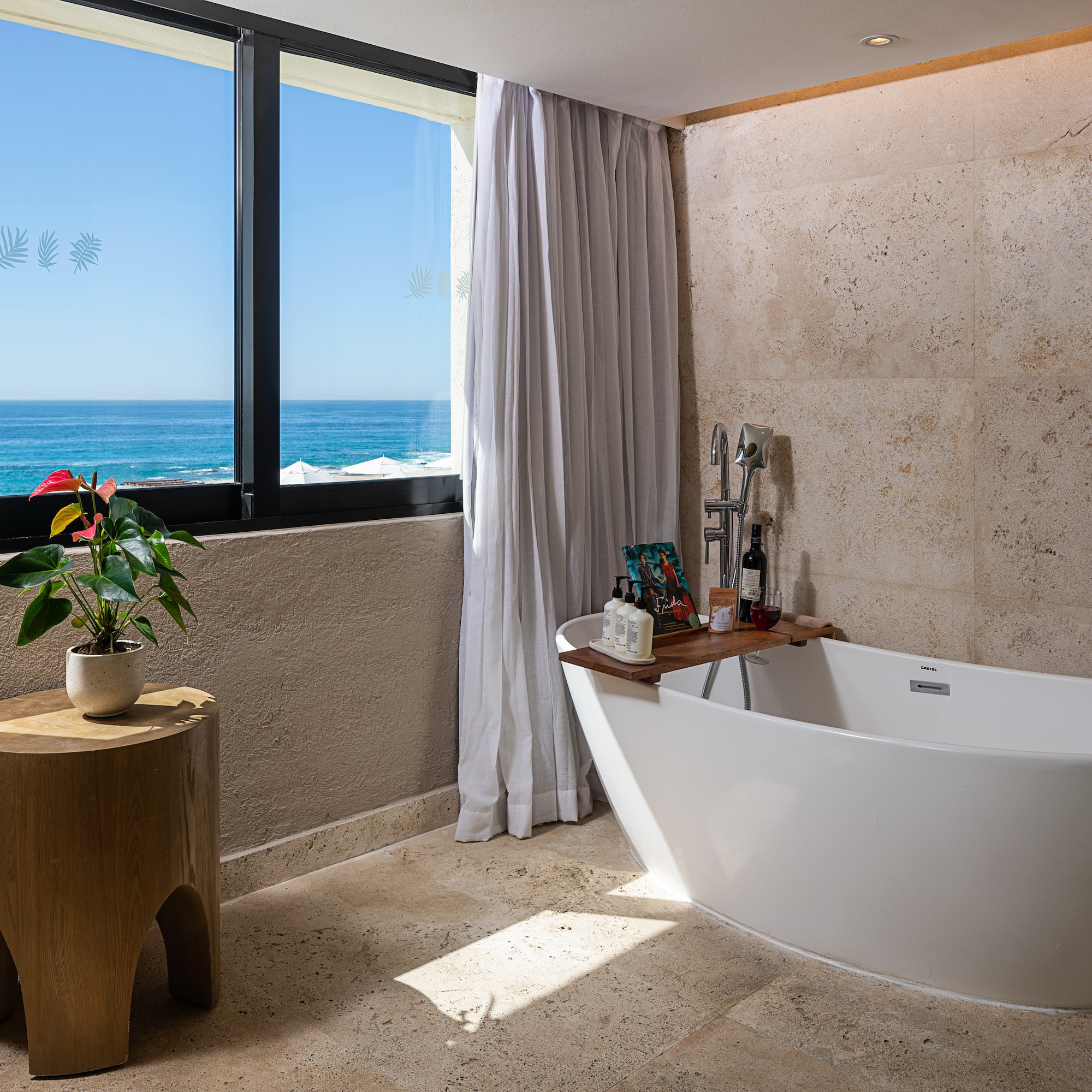a bathroom with a tub and a window