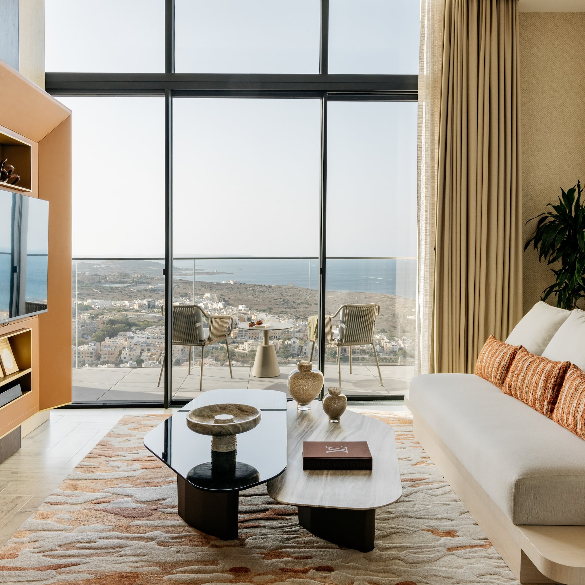 a living room with a large glass wall and a couch