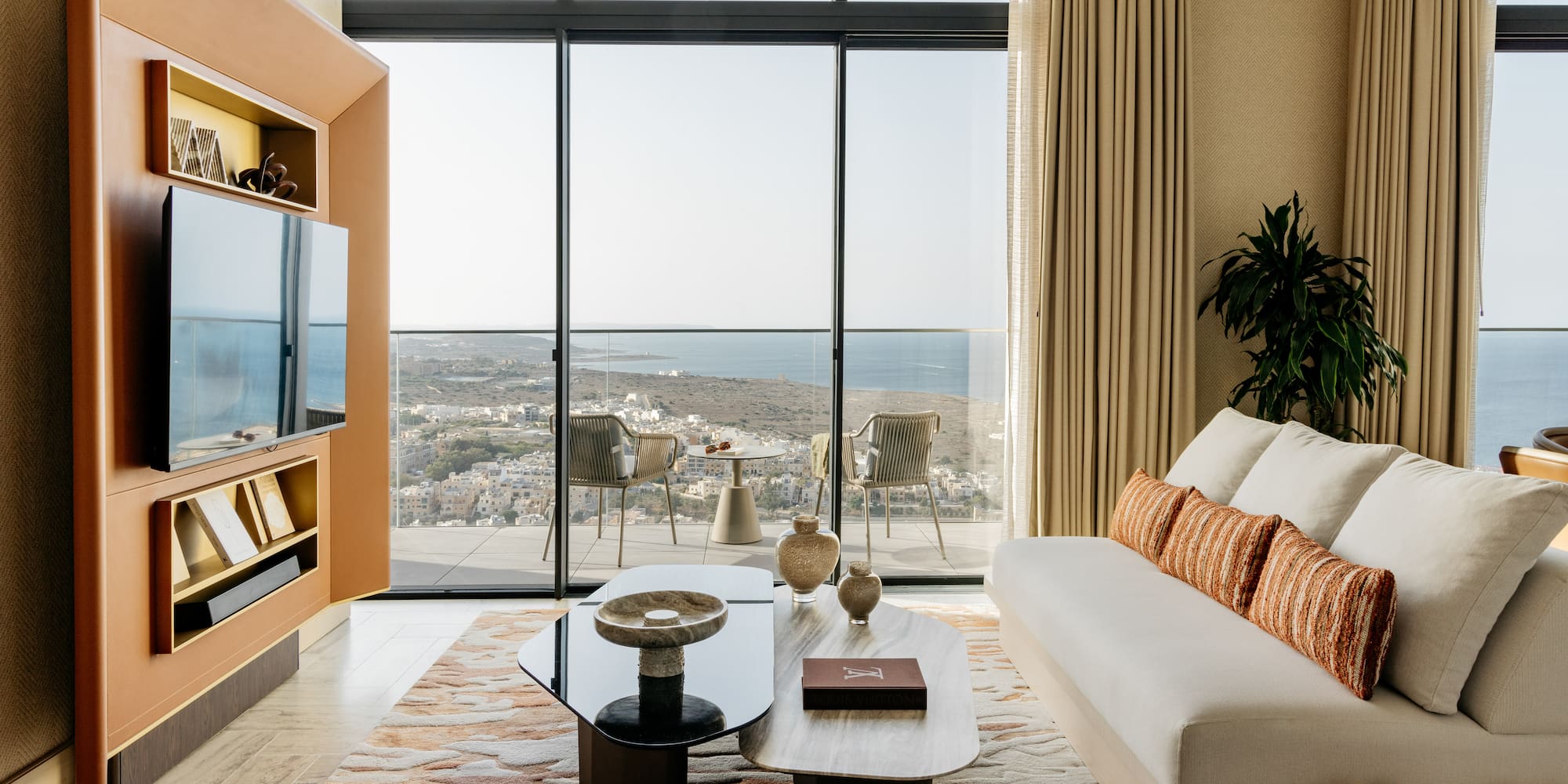 a living room with a large glass wall and a couch