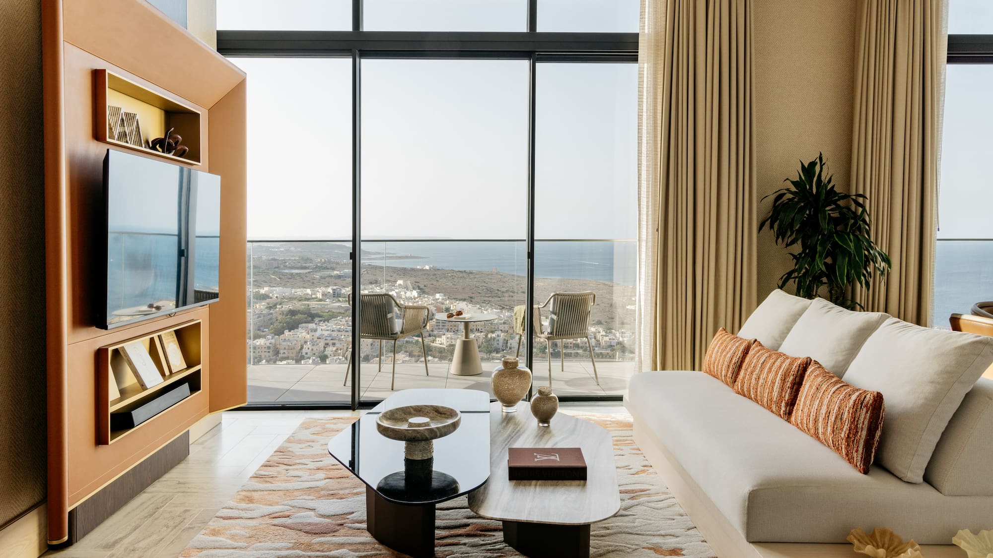a living room with a large glass wall and a couch