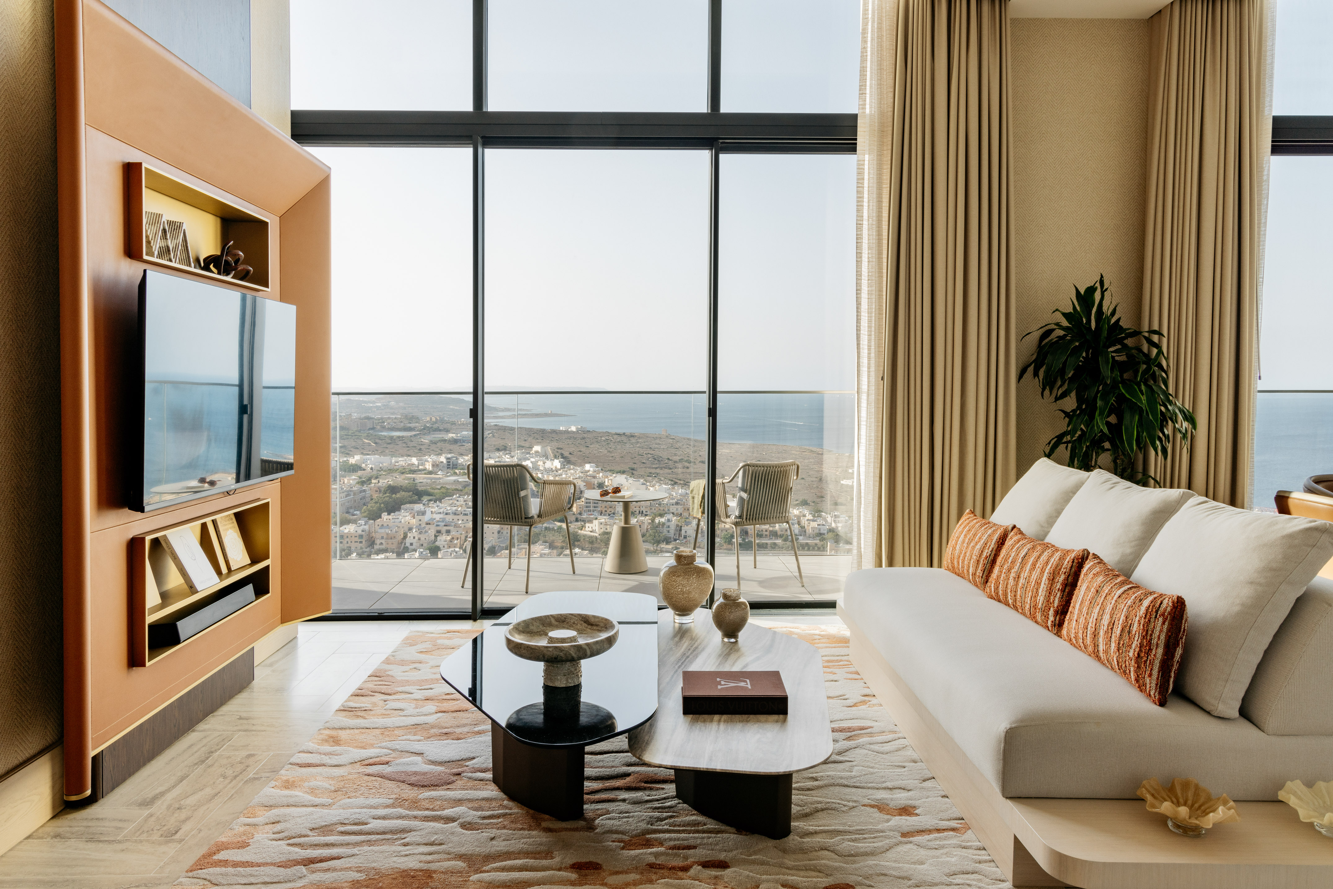 a living room with a large glass wall and a couch