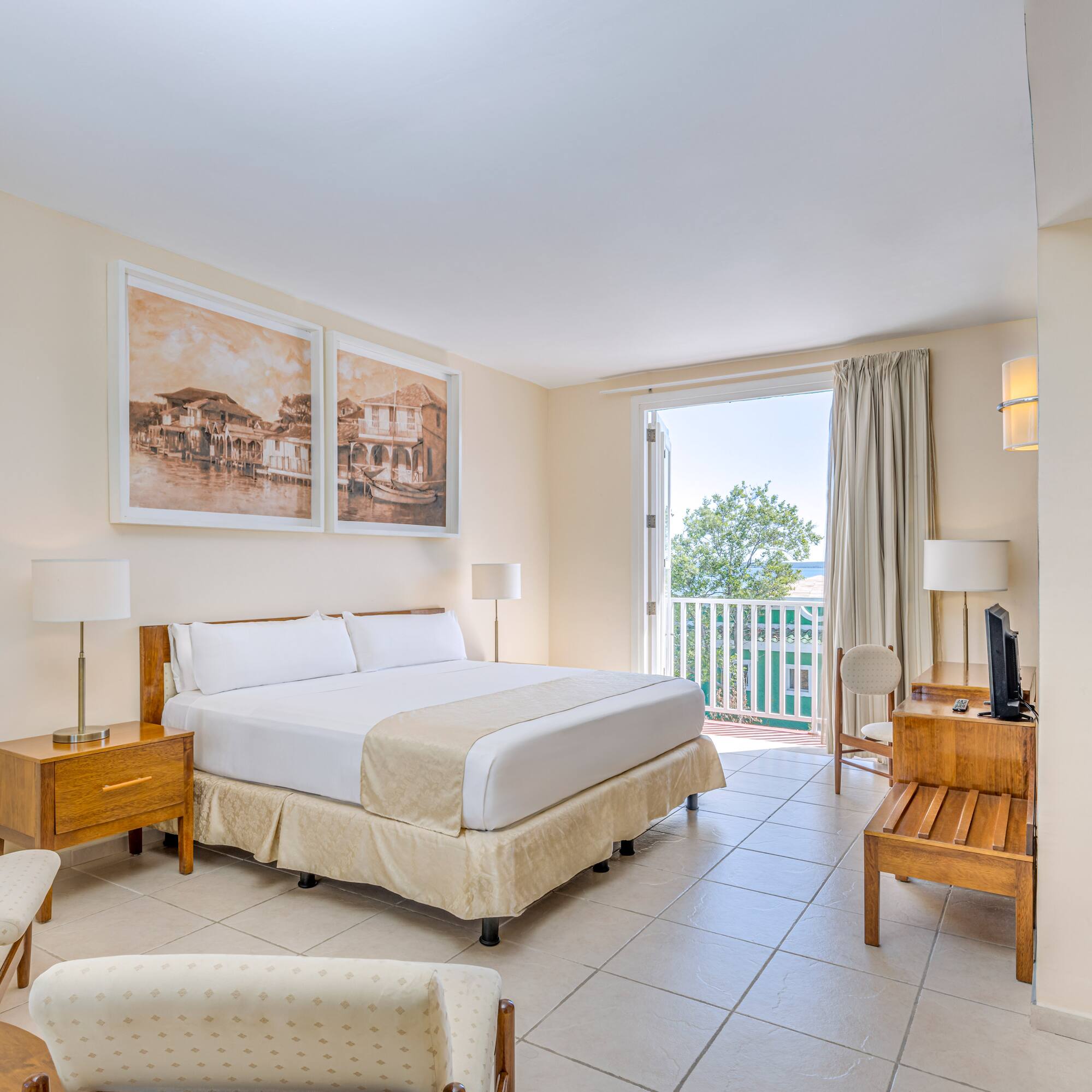 a bedroom with a bed and a table and chairs