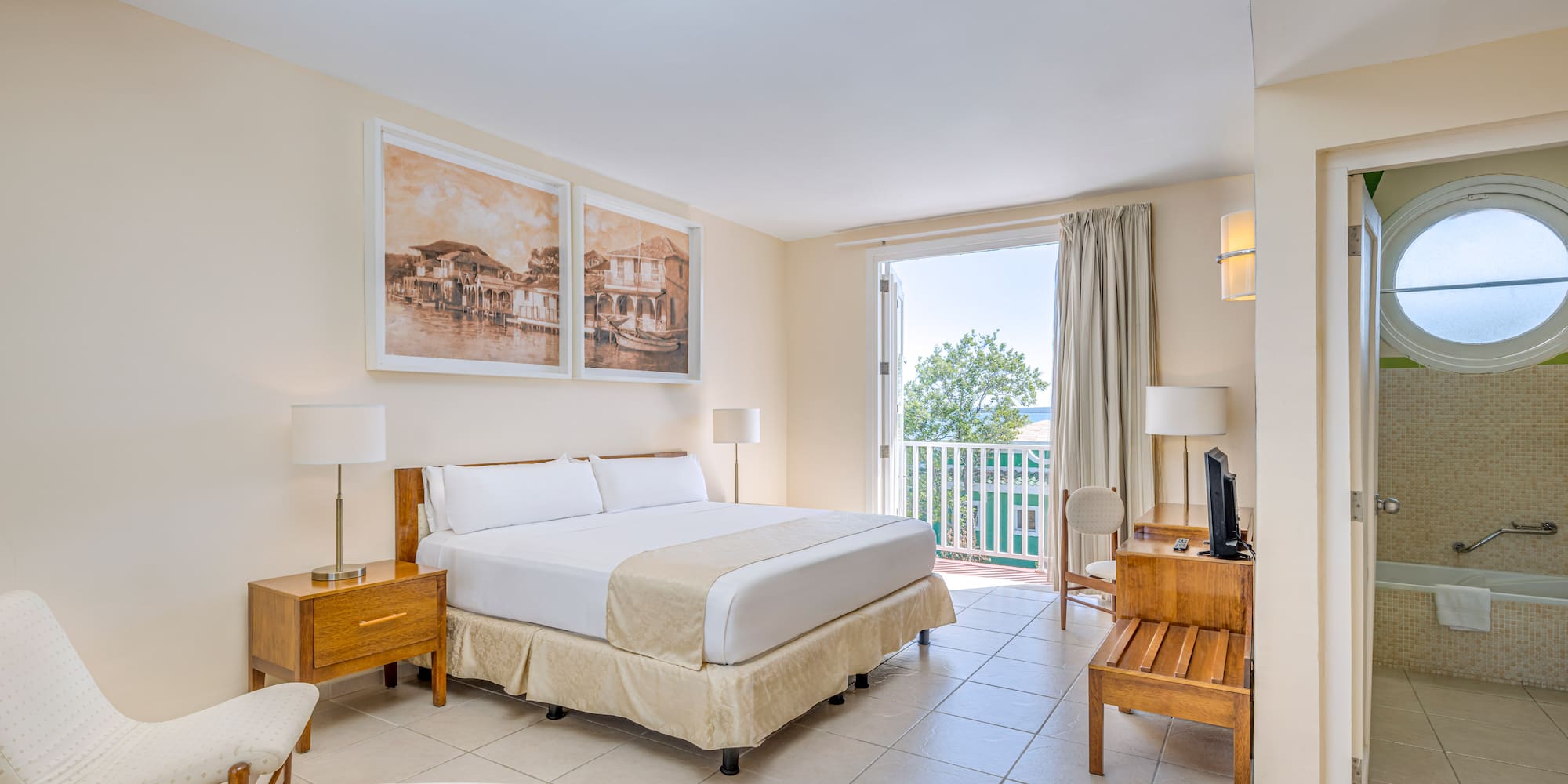 a bedroom with a bed and a table and chairs