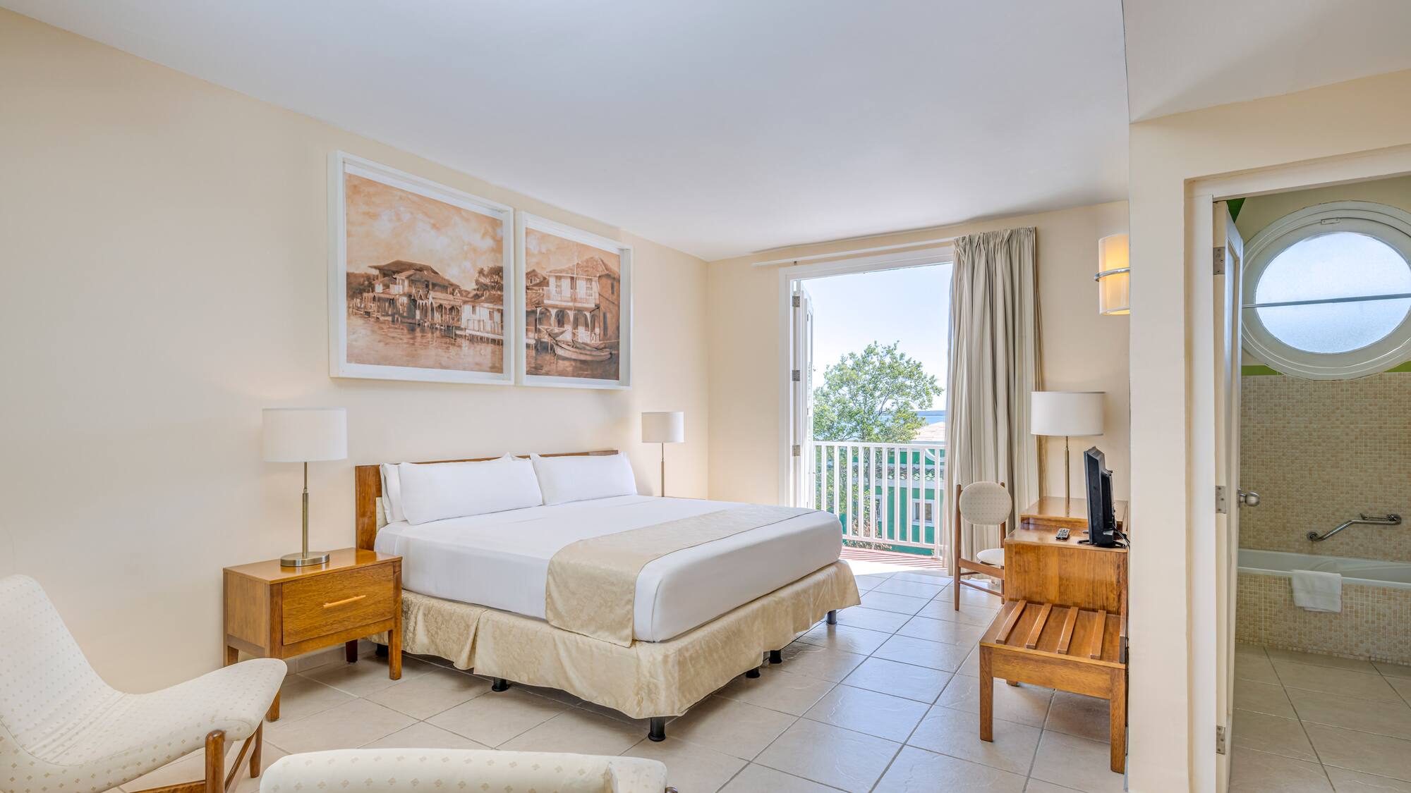 a bedroom with a bed and a table and chairs