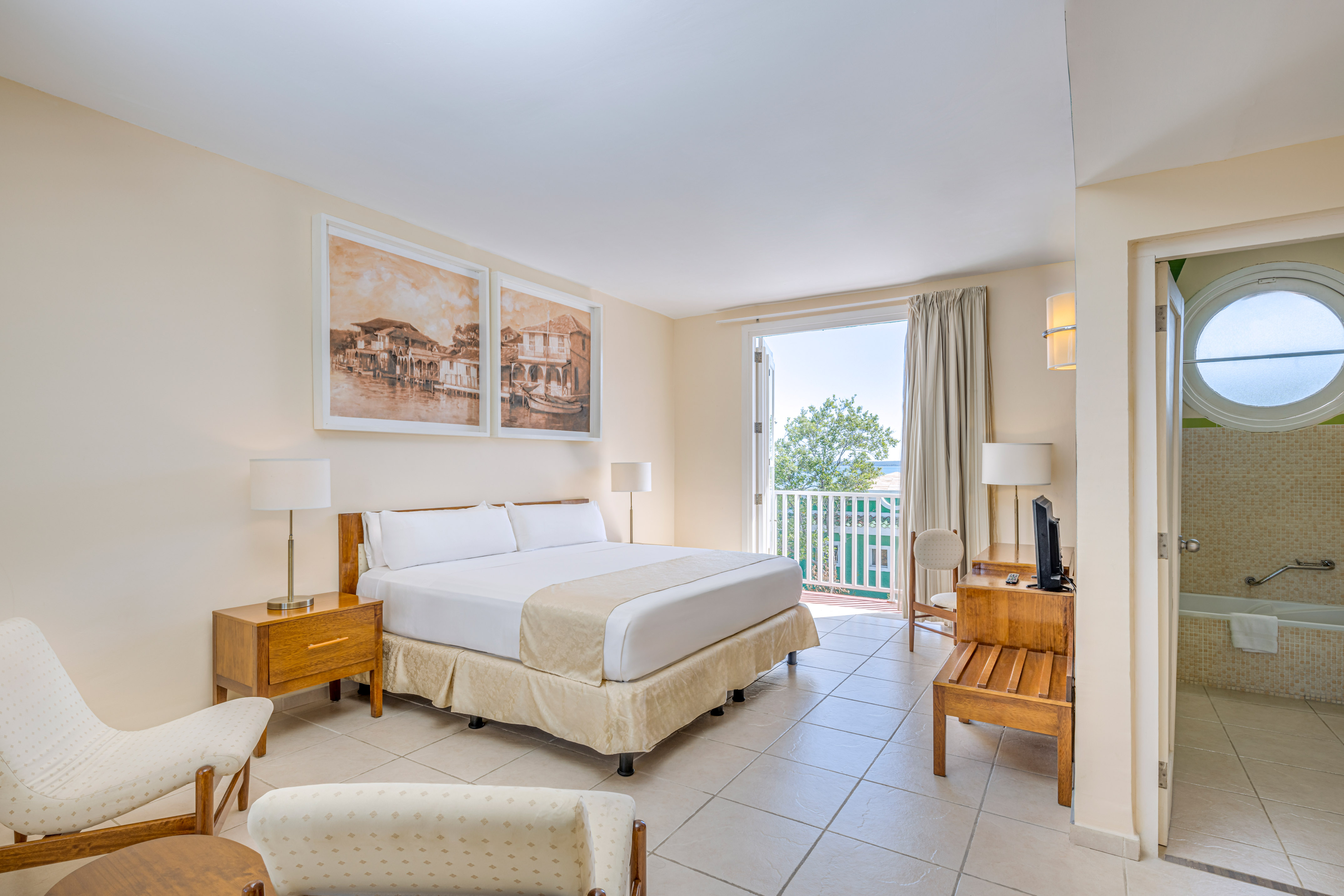 a bedroom with a bed and a table and chairs