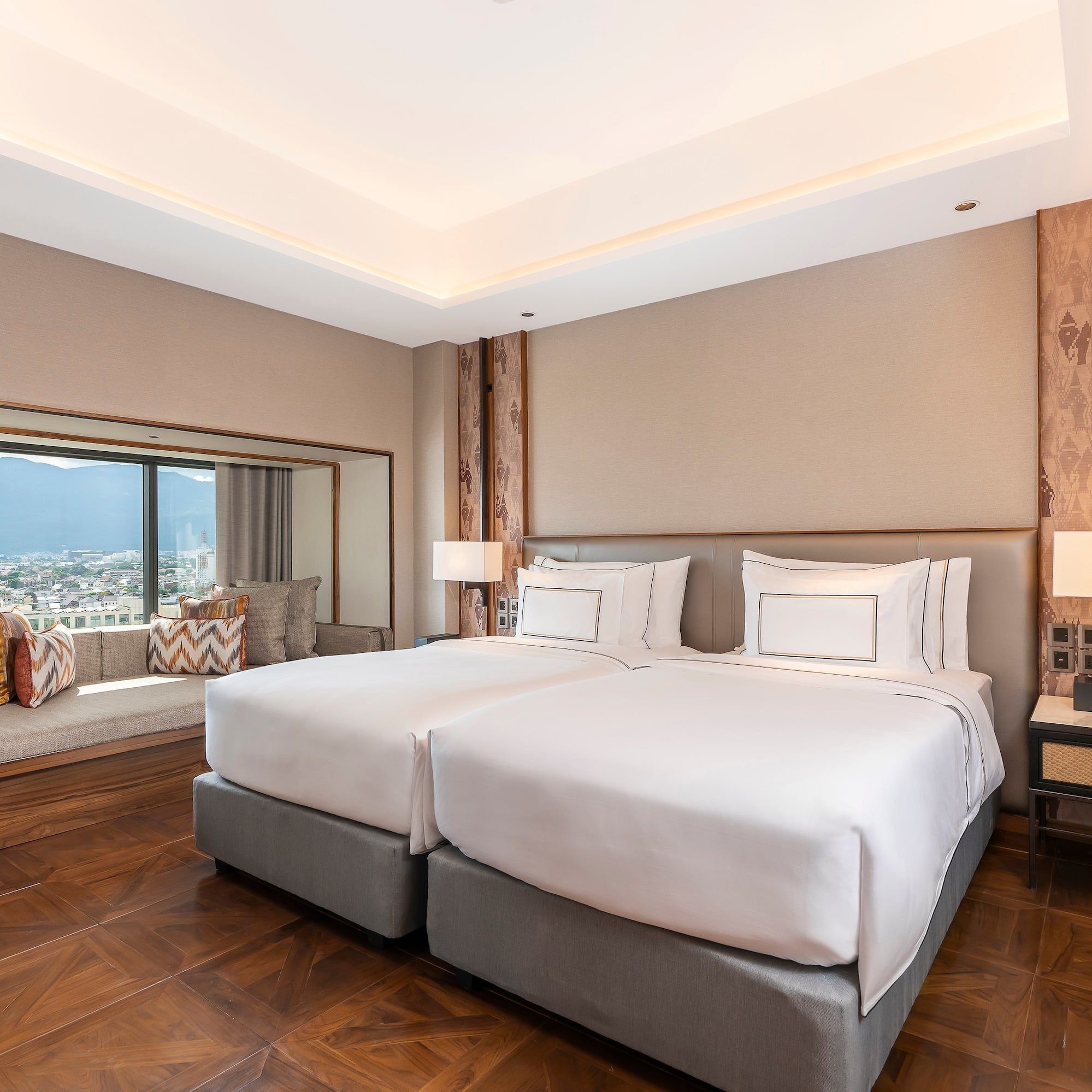 a room with two beds and a window