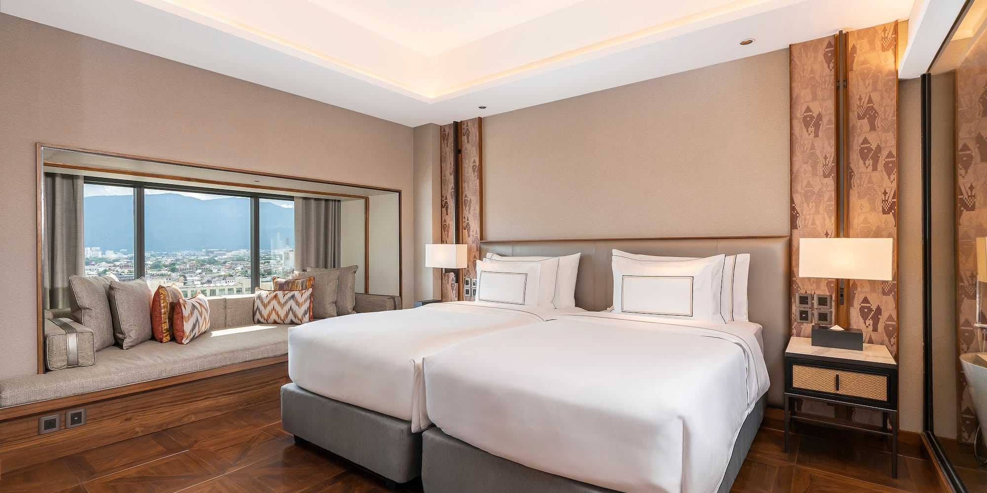 a room with two beds and a window