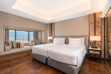 a room with two beds and a window