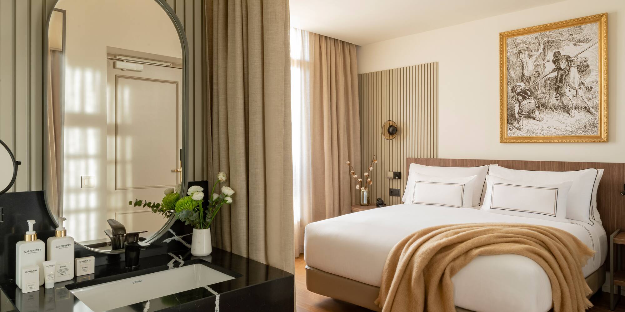 a bedroom with a mirror and a bed