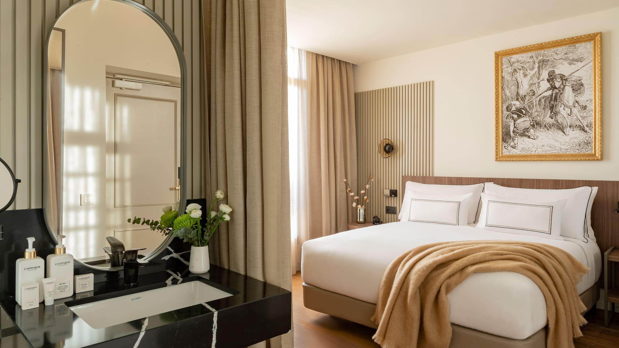 a bedroom with a mirror and a bed