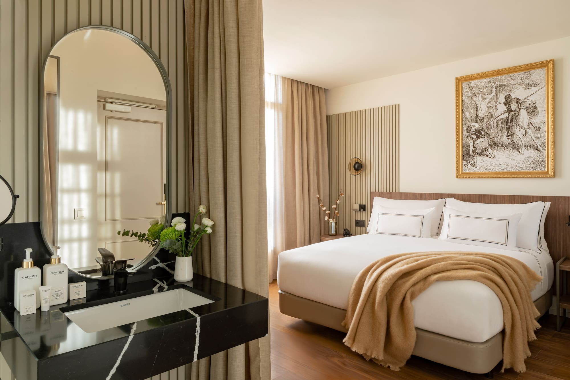 a bedroom with a mirror and a bed