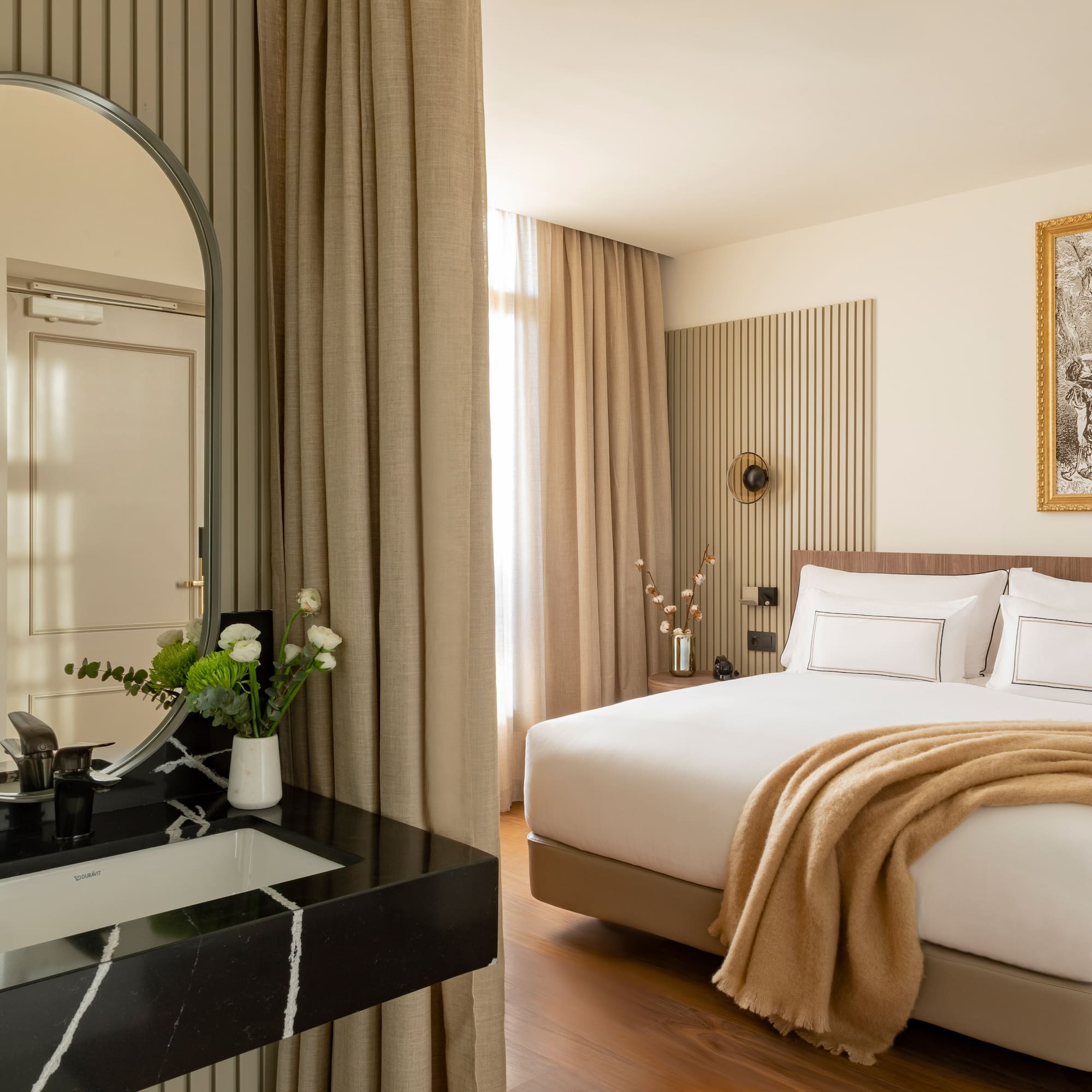 a bedroom with a mirror and a bed