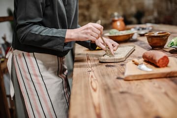 a person holding a fork and a tray of food