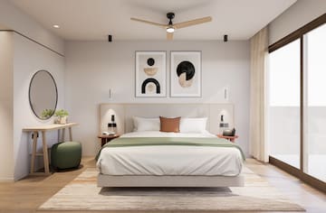 a bedroom with a bed and a desk and artwork