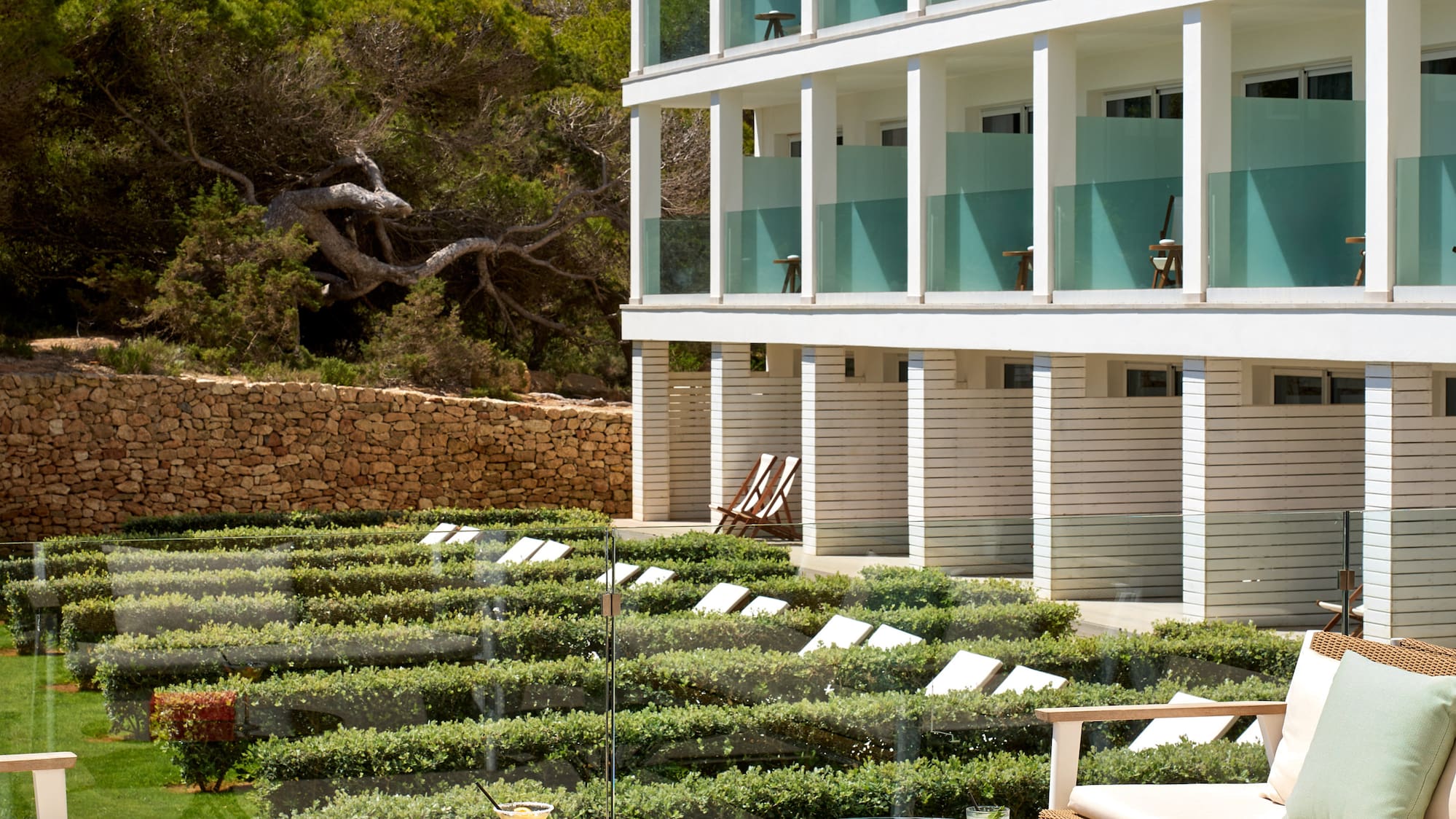 a patio with chairs and a table in front of a building