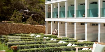 a patio with chairs and a table in front of a building