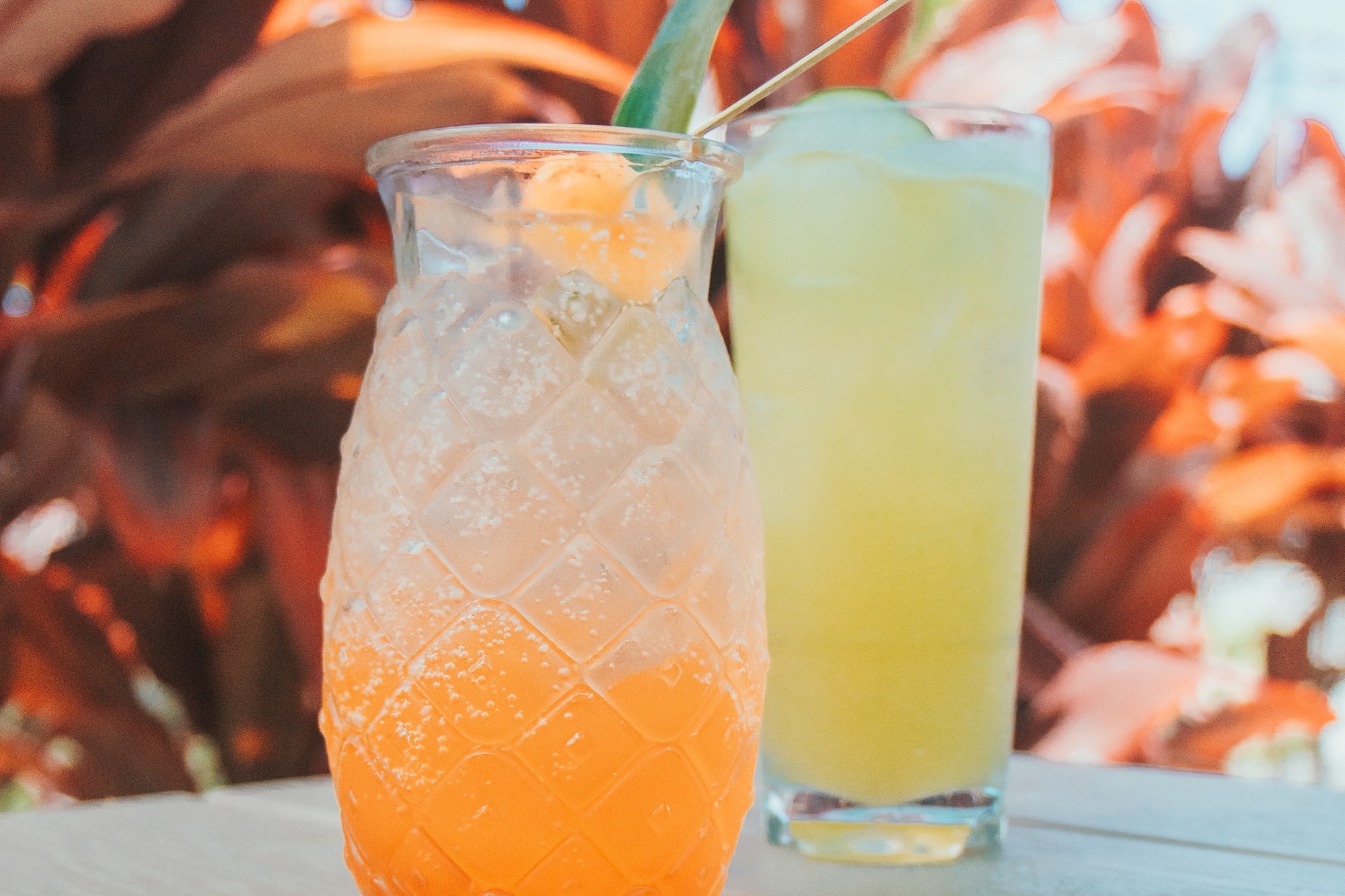 a glass of juice and a drink on a table