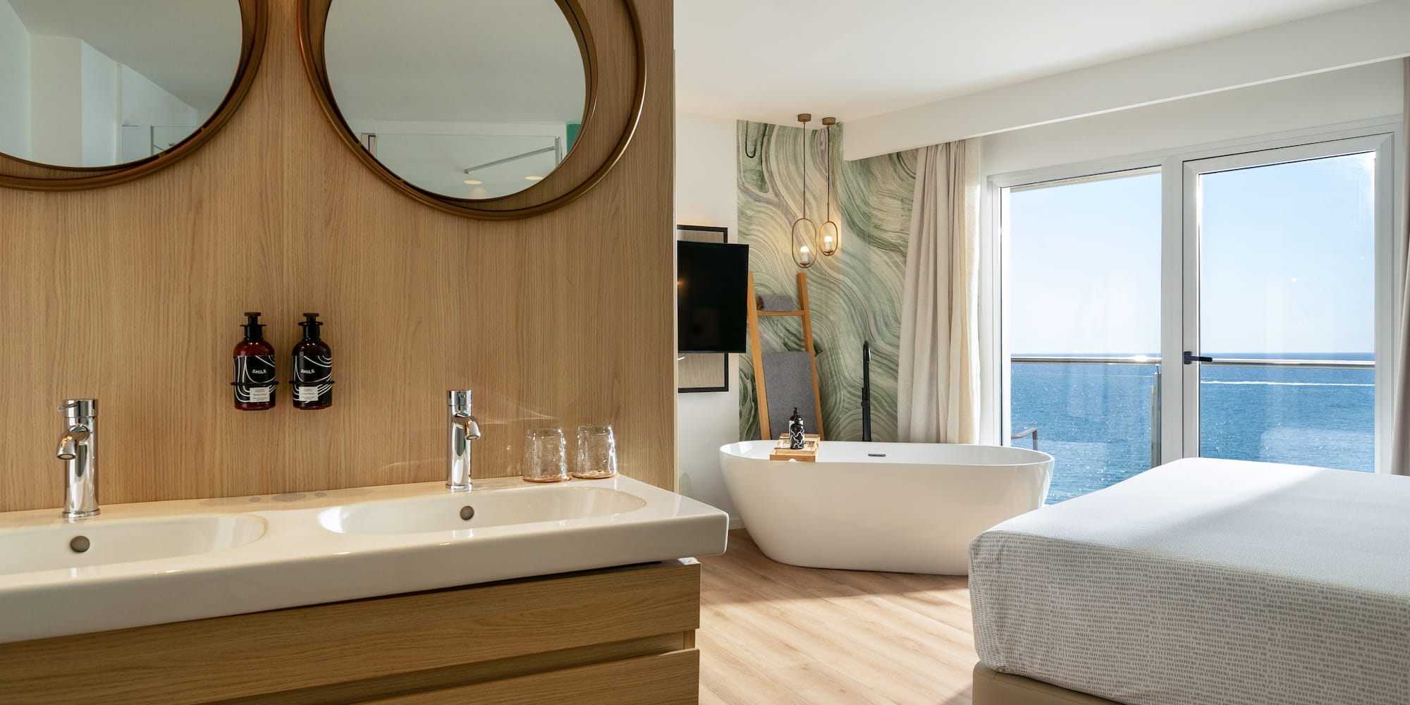 a bathroom with a bathtub and a bed