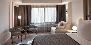 a bedroom with a bed and a lamp