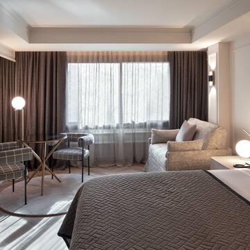 a bedroom with a bed and a lamp