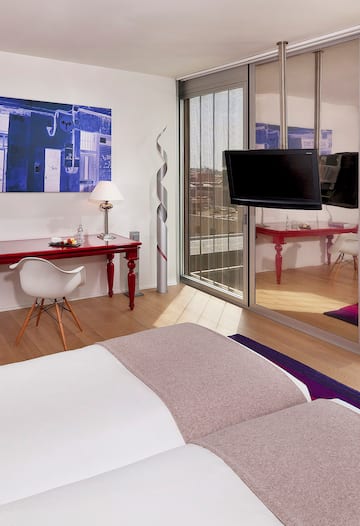 a bedroom with a bed and a desk