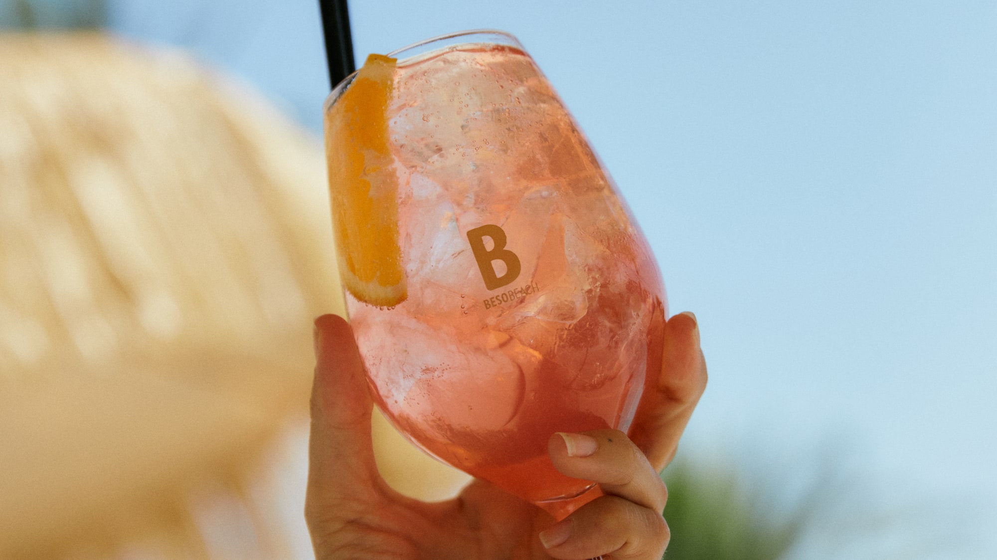 a hand holding a drink