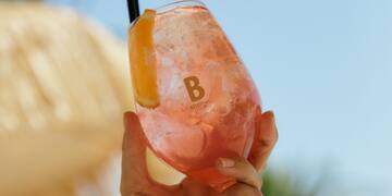 a hand holding a drink