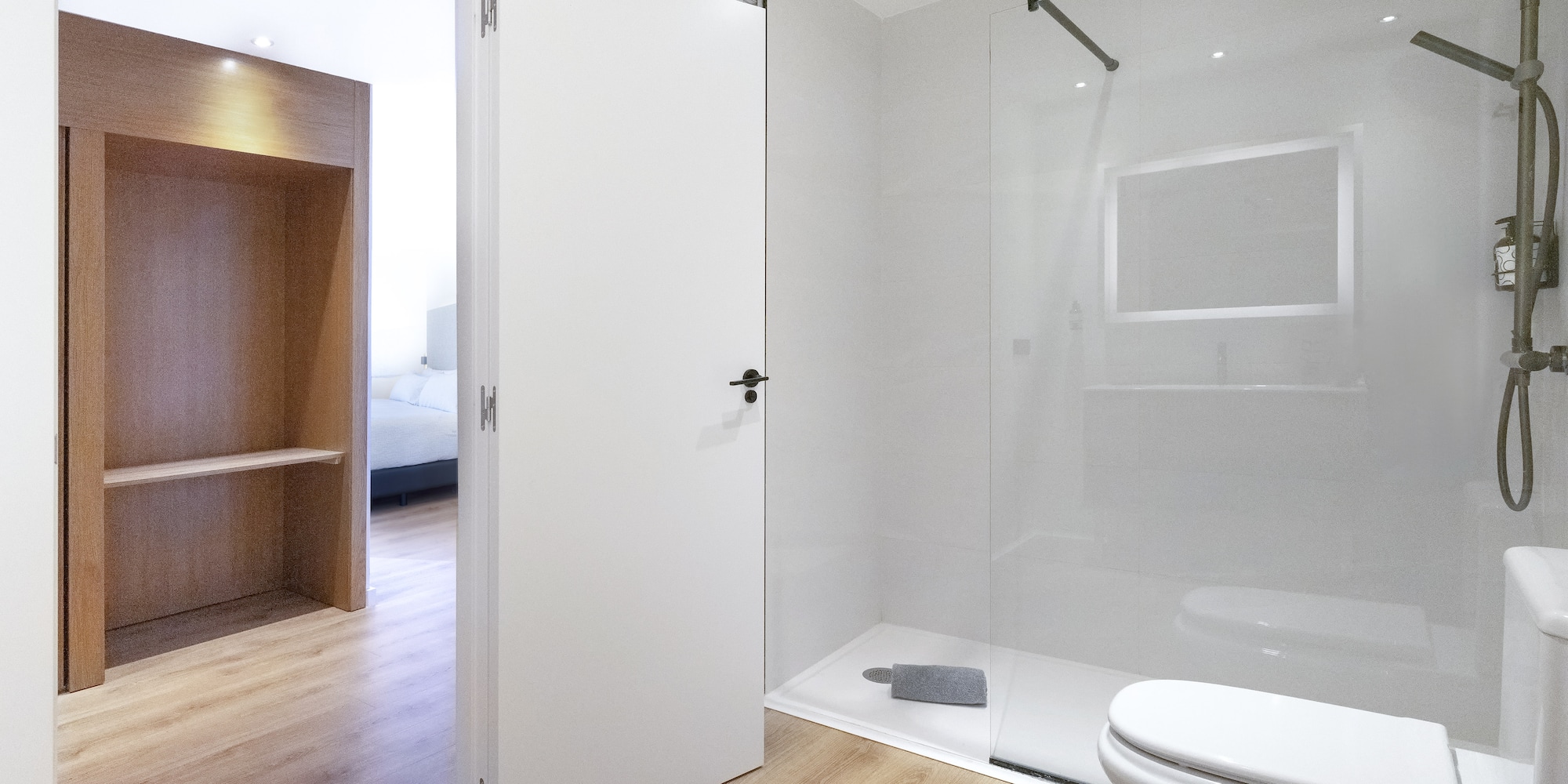 a bathroom with a glass shower and toilet