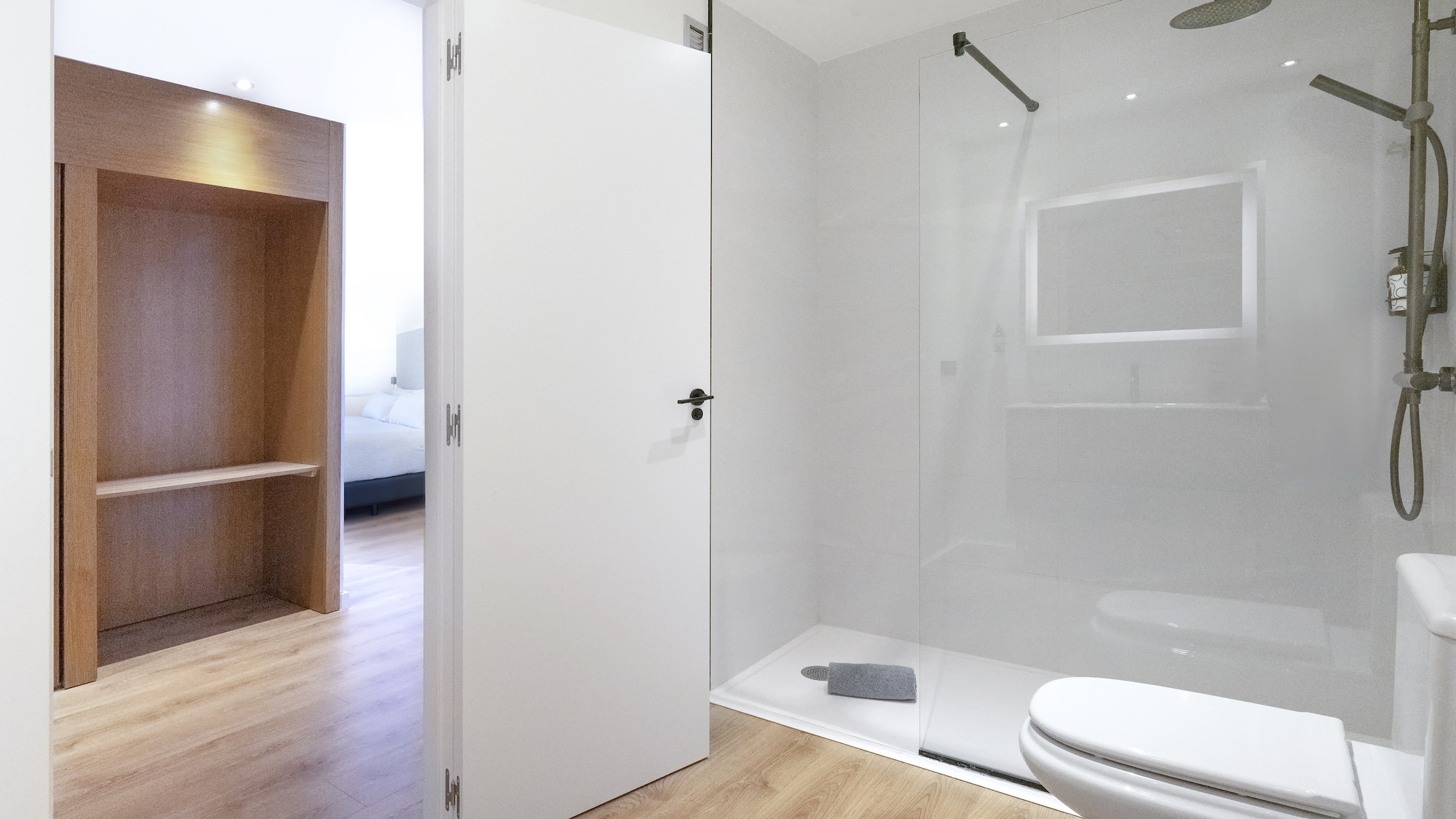 a bathroom with a glass shower and toilet