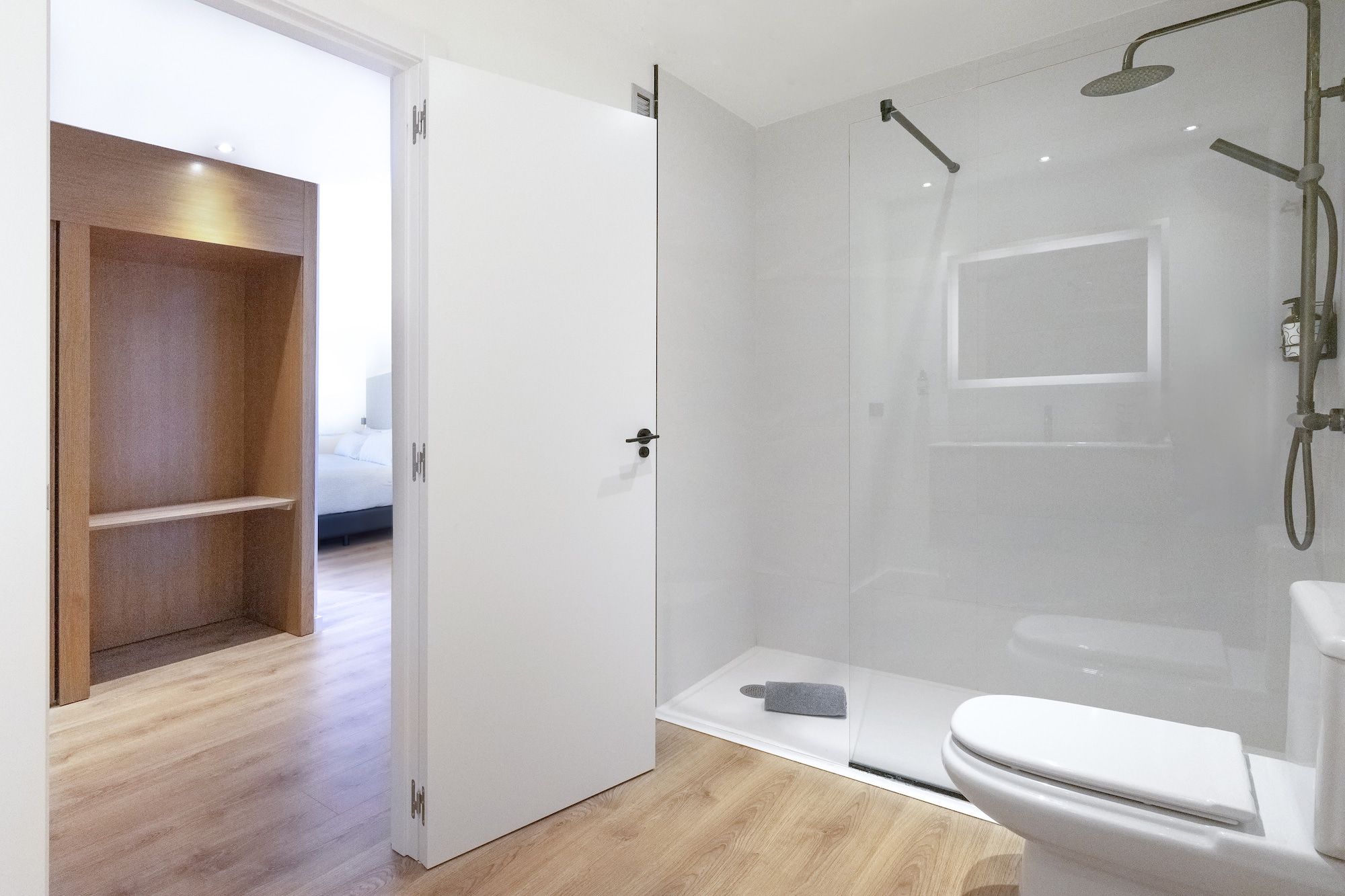 a bathroom with a glass shower and toilet