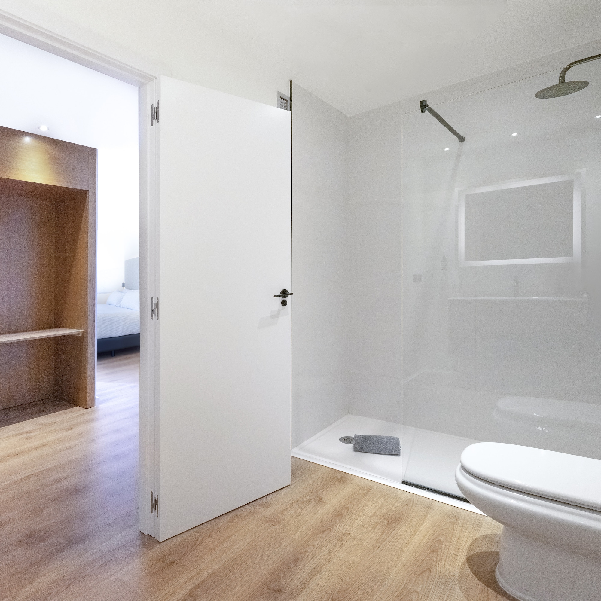 a bathroom with a glass shower and toilet