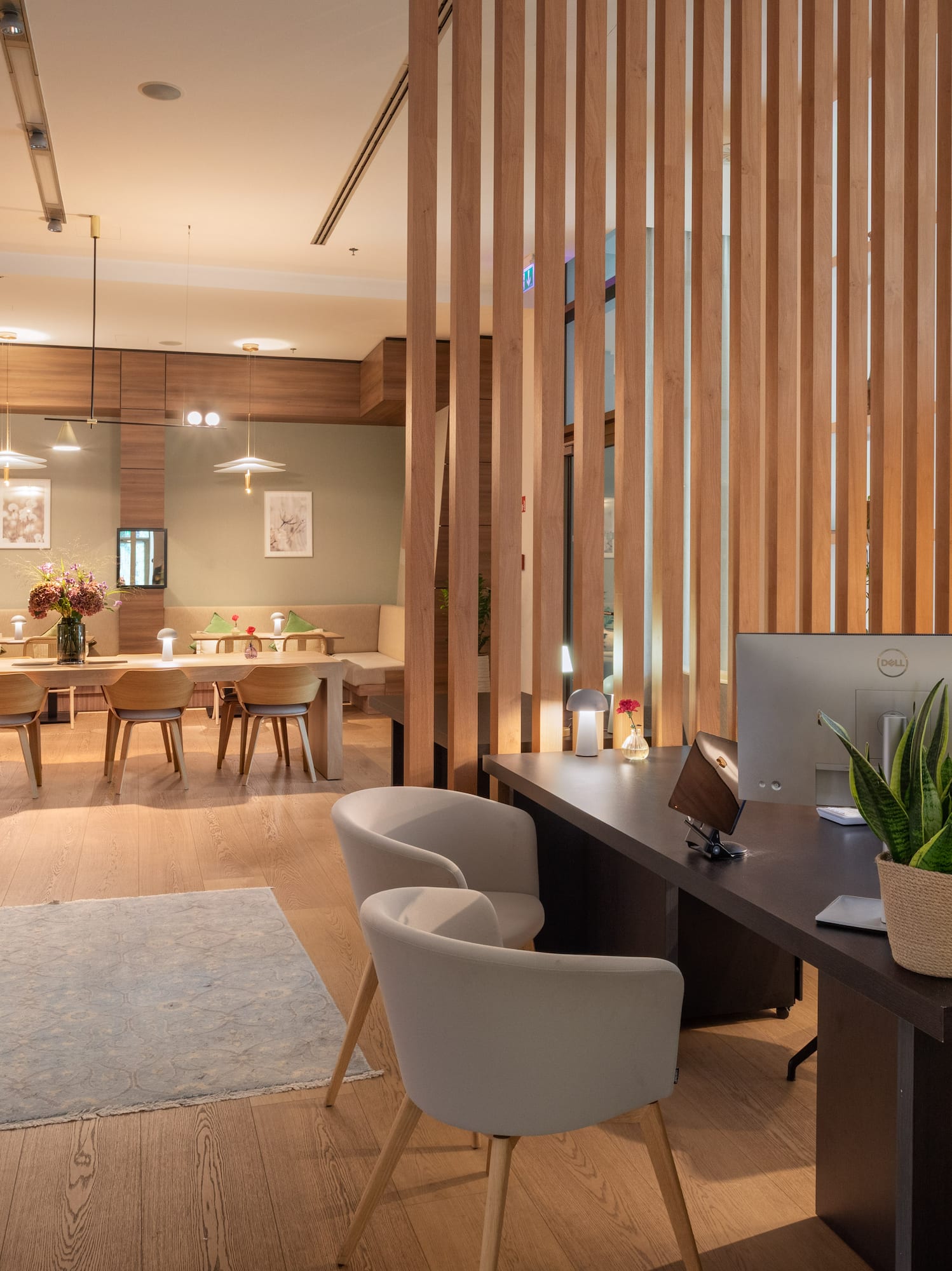 a room with a computer and a table and chairs