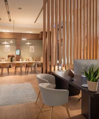 a room with a computer and a table and chairs