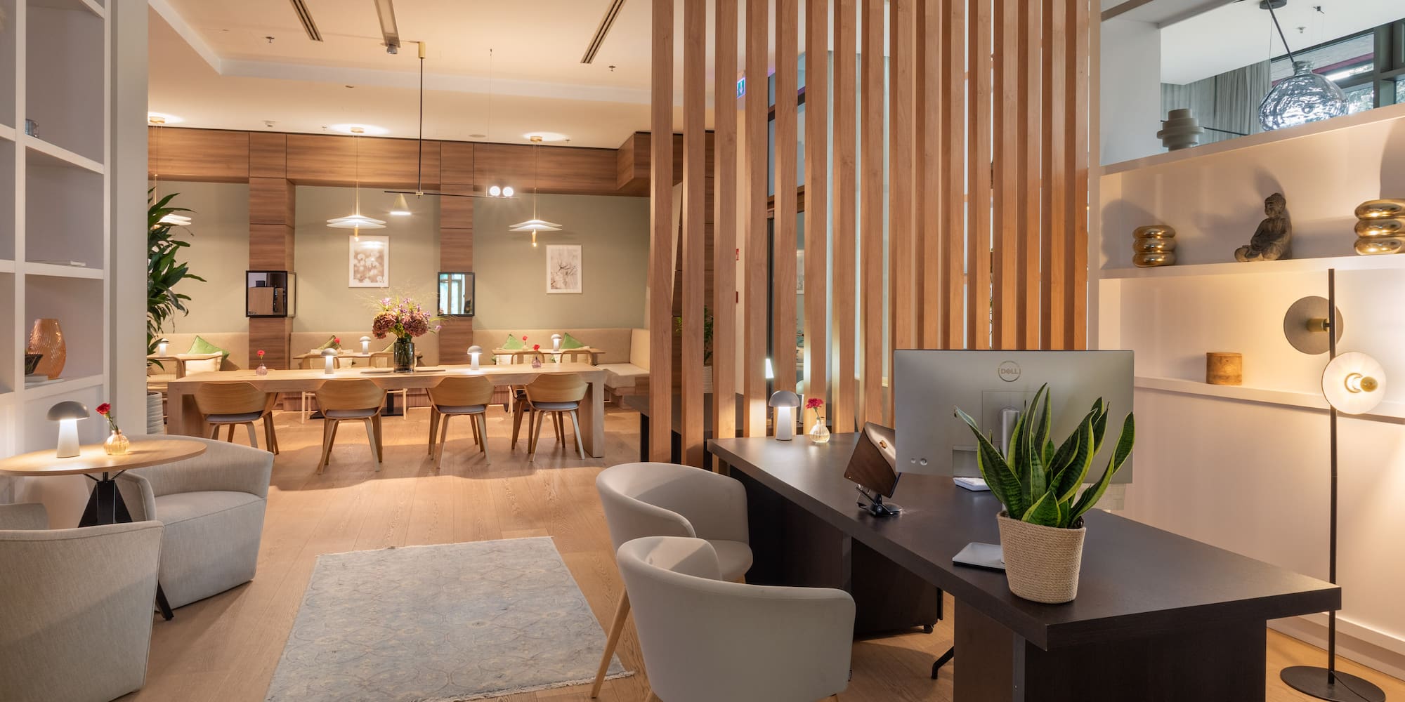 a room with a computer and a table and chairs