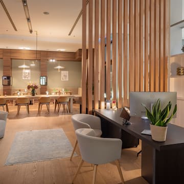 a room with a computer and a table and chairs